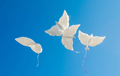 Paper doves in blue sky