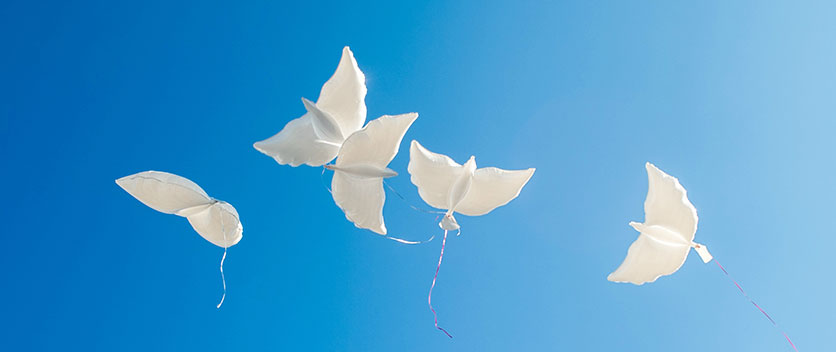 Paper doves in blue sky