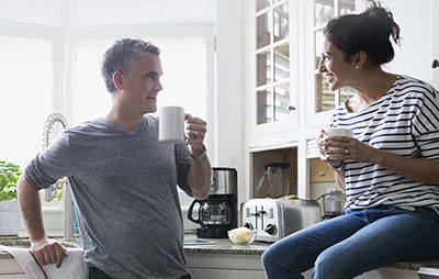 Man and woman talking in kitchen