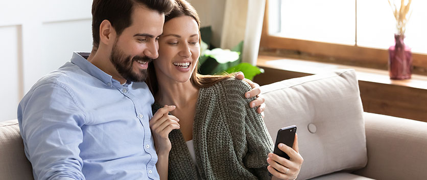 Man and woman viewing mobile phone
