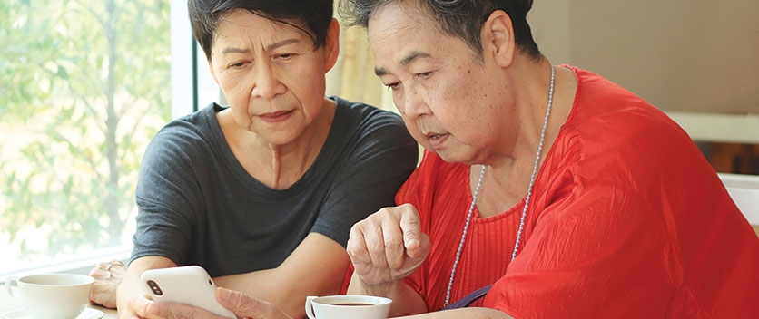 Two women looking at mobile phone