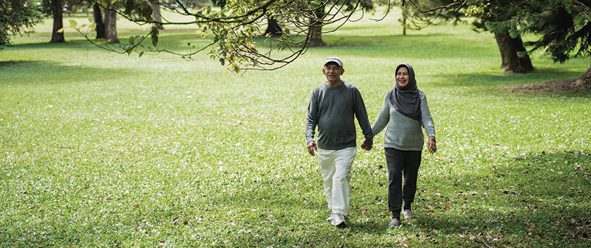 Man and woman walking in park