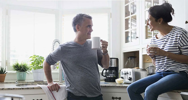 Man and woman talking in kitchen