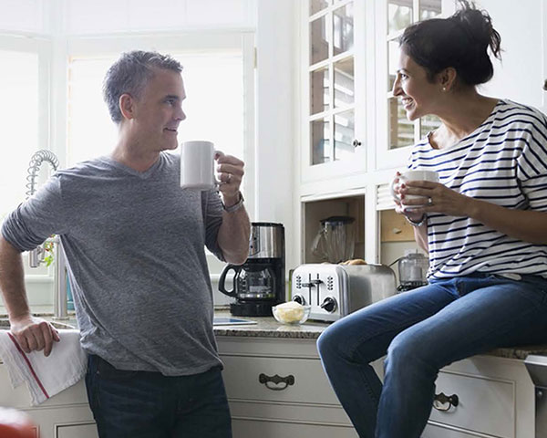 Man and woman talking in kitchen