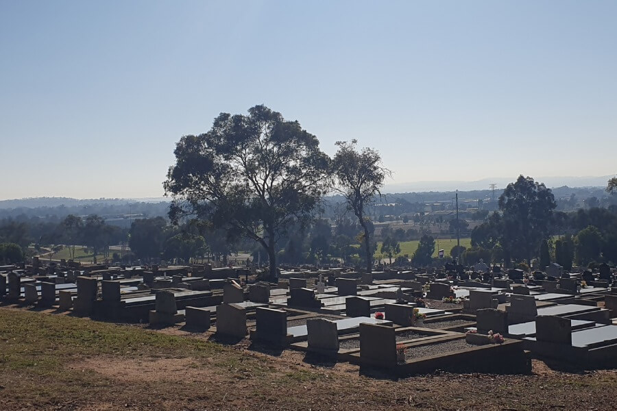 Headstones placed side by side with views of the horizon.